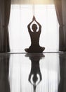 Silhouette of woman Doing yoga at home, meditation, yoga poses, sport, sunset. Sports training