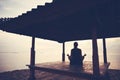 Silhouette of woman doing yoga practice in sun shelter near ocean Royalty Free Stock Photo