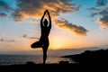 Silhouette of a woman doing yoga stretches on the beach during sunset Royalty Free Stock Photo