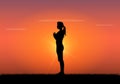 Silhouette of woman doing yoga at sunset