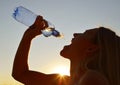 Silhouette of a woman drinking water from bottle Royalty Free Stock Photo