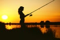 Silhouette of a woman engaged in sport fishing Royalty Free Stock Photo