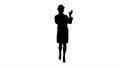 Silhouette Woman engineer talking on the phone while walking. Royalty Free Stock Photo