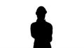 Silhouette Woman engineer talking on the phone while walking. Royalty Free Stock Photo