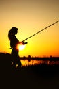 Silhouette of a woman with a fishing rod on nature Royalty Free Stock Photo