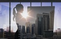 Silhouette of woman with flipboard over city