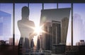 Silhouette of woman with flipboard over city