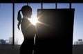 Silhouette of woman with flipboard over office