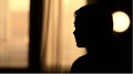 a silhouette of a woman in front of a window generated Royalty Free Stock Photo