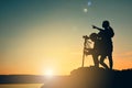 Silhouette woman and girl shooting sunset on the top mountain Royalty Free Stock Photo