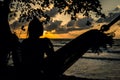 A silhouette woman on a hammock