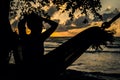 A silhouette woman on a hammock