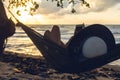 A silhouette woman on a hammock