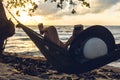 A silhouette woman on a hammock