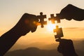 Silhouette Woman hands connecting couple jigsaw puzzle piece against sunrise, Business solutions, target, success, goals and Royalty Free Stock Photo