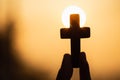 Silhouette of woman hands praying with cross in nature sunrise background, Crucifix, Symbol of Faith. Christian life crisis