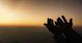 Silhouette of woman hands praying for worship God at sky background. Christians pray to jesus christ for calmness. In morning Royalty Free Stock Photo