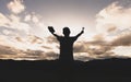 Silhouette of a woman with hands raised in the sunset concept for religion, worship, prayer and praise, Religious concepts Royalty Free Stock Photo