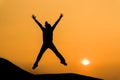 Silhouette of woman in happy jump on orange sunset sky Royalty Free Stock Photo