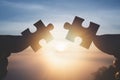 Silhouette Woman haSilhouette Woman hands connecting couple jigsaw puzzle piece against sunrise, Business solutions, target,