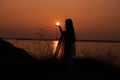 silhouette of woman having sun on palm