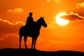 Silhouette  woman and horse running across horizon as the sun goes down Royalty Free Stock Photo