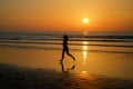 Silhouette of woman jogger running on sunset beach with reflection, fitness and sport Royalty Free Stock Photo