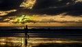 Silhouette of a woman jogging and watching the sunrise on Camboriu beach, Brazil