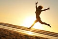 Silhouette, woman and jump at beach for sunset, happiness and celebration in nature for freedom. Energy, success and Royalty Free Stock Photo