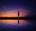 A silhouette of a woman jumping for joy on beautiful sunset Royalty Free Stock Photo