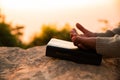 Silhouette of woman kneeling down praying for worship God at sky background. Christians pray to jesus christ for calmness. In Royalty Free Stock Photo