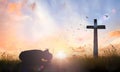 Woman hand kneeling for worship God over cross