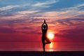 Silhouette of Woman Meditating in Yoga pose by the Sea at Sunset. Nature Meditation Concept. Low key photo. relax time Royalty Free Stock Photo