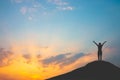 Silhouette of woman on mountain top over sky and sun light background,business, success