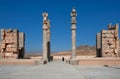 Silhouette of a woman in a Muslim hijab in between ruined columns in Persepolis