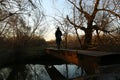 Silhouette of a woman at night crossing the river through the metal bridge Royalty Free Stock Photo