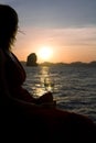 Silhouette of a woman and ocean sunset