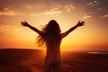 Silhouette of a woman with open arms on a sunset background, Excited girl standing and celebrating success on a sunset background Royalty Free Stock Photo