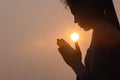 Silhouette of a woman paying respects and praying A symbol of gratitude to the Lord Royalty Free Stock Photo