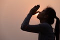 Silhouette of a woman paying respects and praying A symbol of gratitude to the Lord