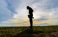 Silhouette of a woman photographer standing in the beach sunset. Blue sky sunset Background. Royalty Free Stock Photo