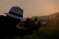 Silhouette of woman photographer during sunset, Asian tourist take the photo