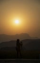 Silhouette woman photographer at sunset, person taking a photo landscape at the high mountain Royalty Free Stock Photo