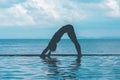 Silhouette woman practice yoga Downward Facing dog or yoga Adho Mukha Svanasana pose meditation summer vacation on the pool