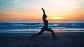 Silhouette Woman practice yoga warrior pose to meditation with summer vacation beach happiness and relaxation. Calm female Royalty Free Stock Photo