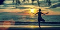 Silhouette woman practicing yoga on beach at surrealistic sunset. Royalty Free Stock Photo