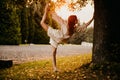 Silhouette woman practicing yoga in the forest at sunset. Meditation workout concept. Royalty Free Stock Photo