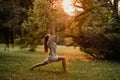 Silhouette woman practicing yoga in the forest at sunset. Meditation workout concept. Royalty Free Stock Photo