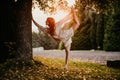 Silhouette woman practicing yoga in the forest at sunset. Meditation workout concept. Royalty Free Stock Photo