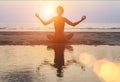 Silhouette woman practicing yoga on Ocean beach at surrealistic sunset. Royalty Free Stock Photo